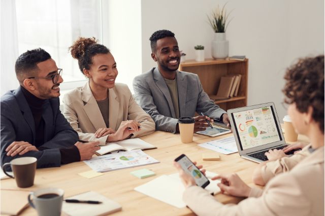 a team sitting around a desk working together
