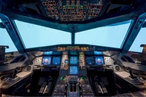 The inside of an airplane cockpit that shows all the controls and tech that an embedded software engineer will have worked on