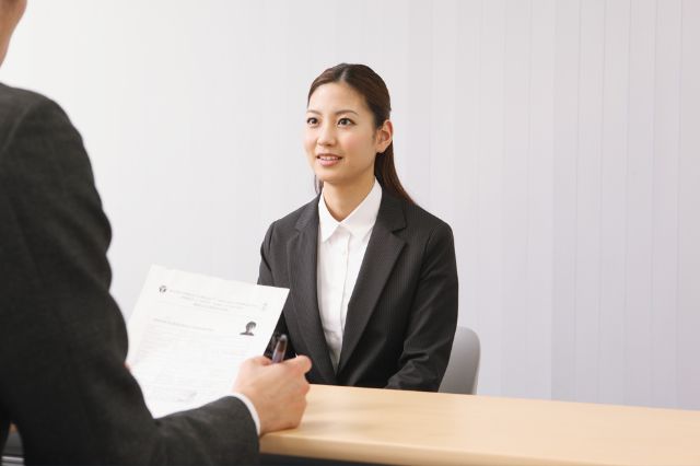 a graduate job seeker sitting across from an interviewer at a job interview